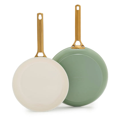 Two green frying pans with gold handles on a white background