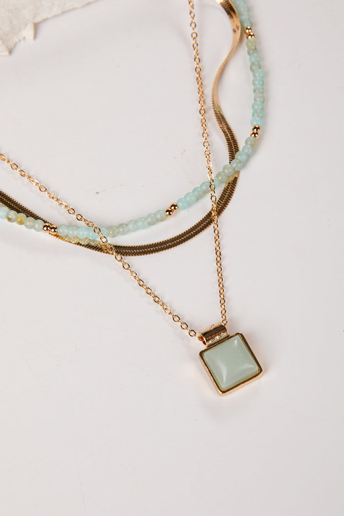 Gold and mint layered necklace with pendant