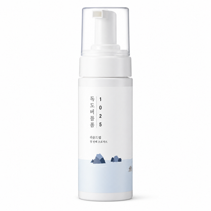 white foaming cleanser bottle with a clear pump cap and minimalist korean packaging on a clean white background.