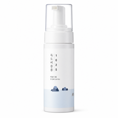 white foaming cleanser bottle with a clear pump cap and minimalist korean packaging on a clean white background.