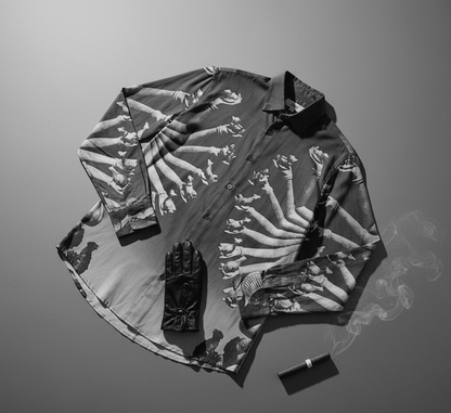 SB Sahasrabahu shirt laid flat with a black glove and a lighter, showing the Hevajra arms artwork