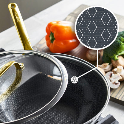Gold ceramic-coated wok with lid, 12-inch size, displayed with assorted vegetables beside it.
