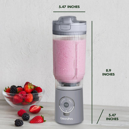 Portable blender with pink smoothie and berries on a white background, showing dimensions.