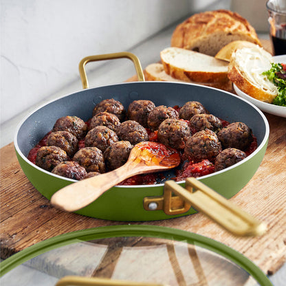Stanley Tucci 12-inch ceramic nonstick frypan with lid, Tuscan Olive color, holding meatballs in tomato sauce. Bread and salad nearby.