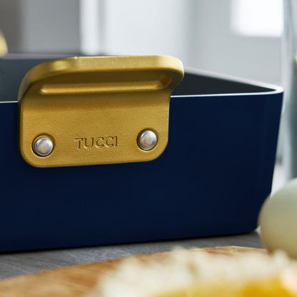 Ceramic lasagna pan in Marino Blue with a gold handle embossed with TUCCI.