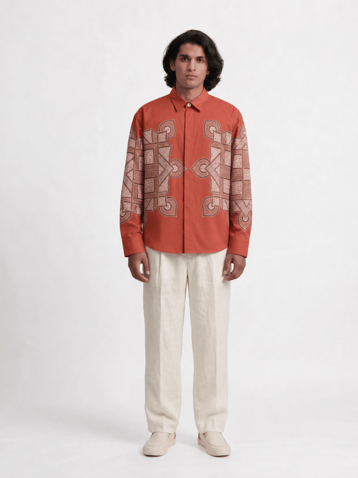 Man wearing the red Terra Rangoli shirt with cream trousers, full length front view