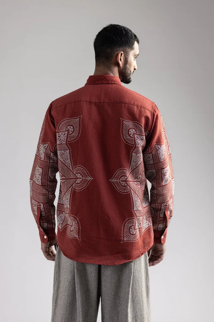 Man wearing the Terra Rangoli shirt with grey trousers, waist-up back view, looking to the side