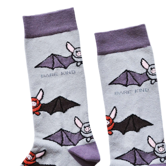 Pair of socks with bat designs and 'Bare Kind' branding on a light gray background