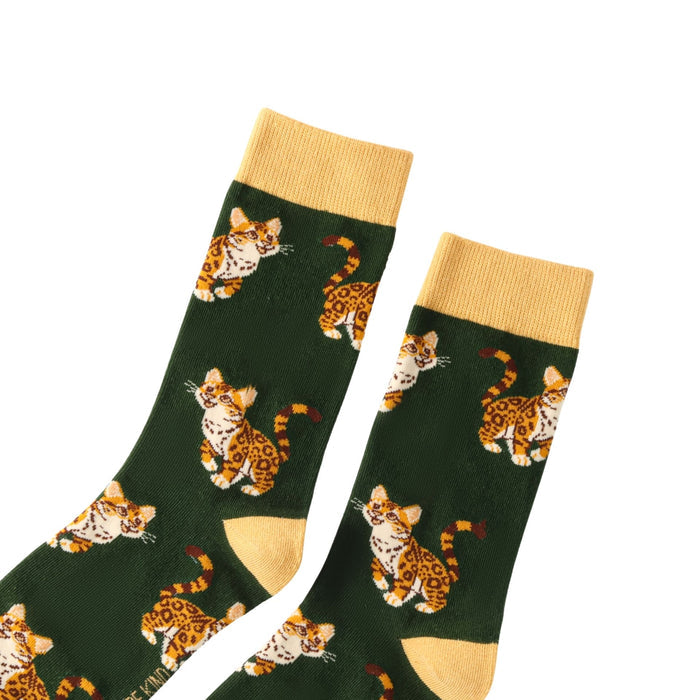 Green socks with leopard pattern and yellow cuffs and toes on a white background