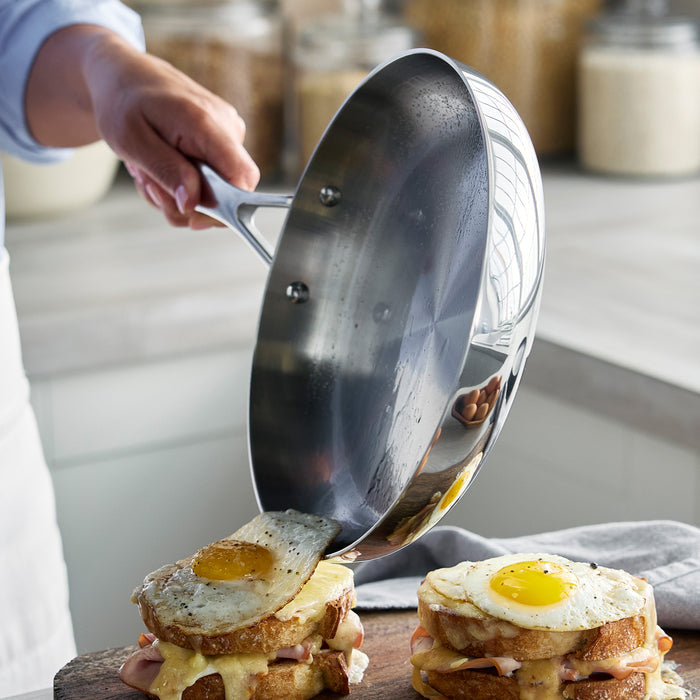 Stainless steel frypan from the Valencia Pro Set on stovetop, frying an egg.